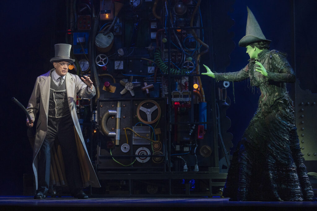 Simon Burke as the Wizard with Sheridan Adams as Elphaba on stage of Wicked. 